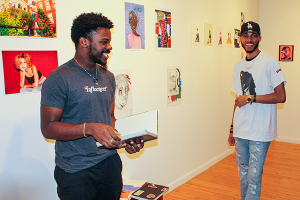 2 students smiling at an art exhibit at the BSU Anderson Gallery