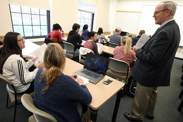 Professor Mark Crowley talking to a student during Accounting class