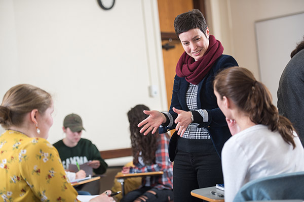 Dr. Sarah Wiggins talks to students who are working in pairs in class