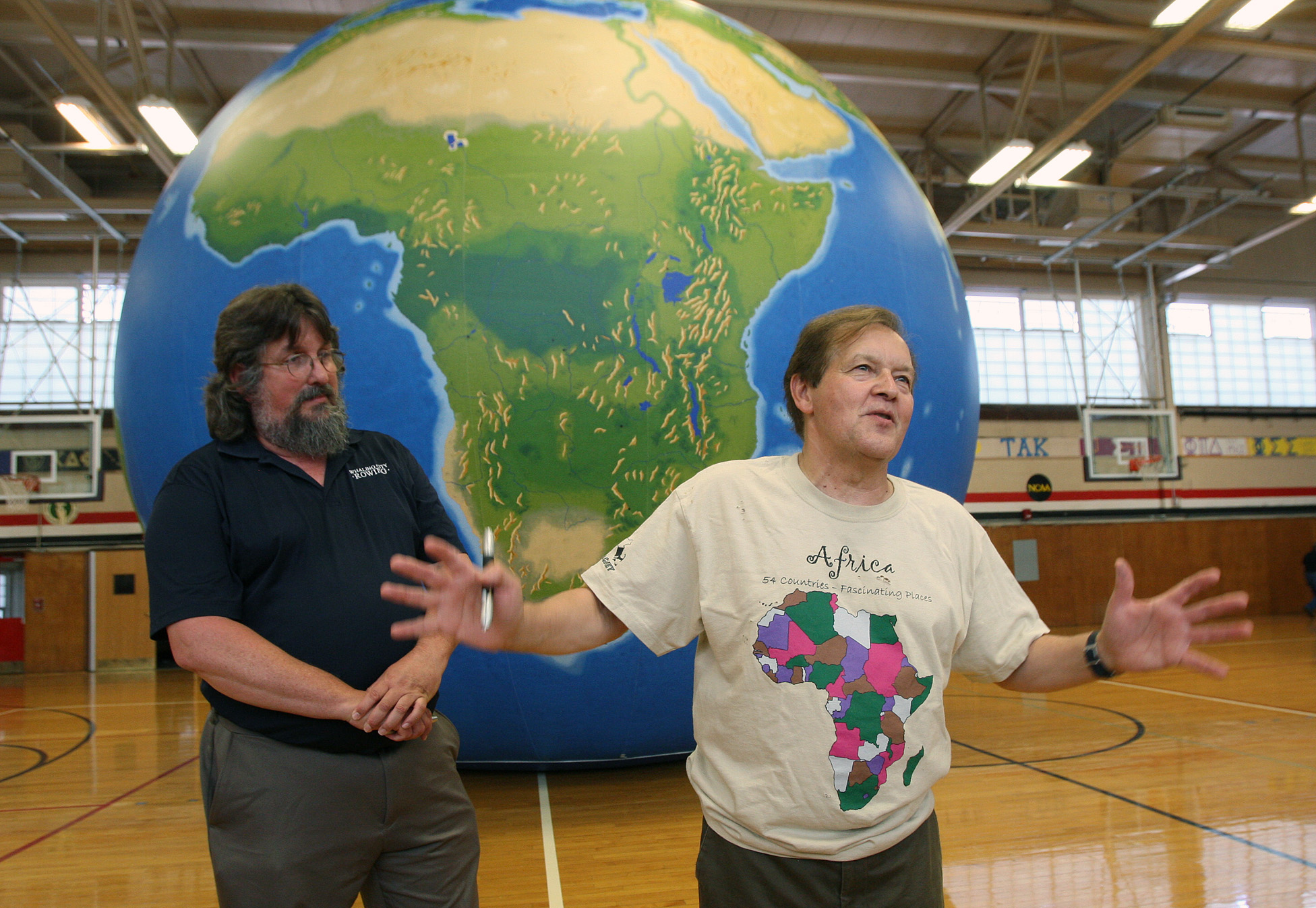 Dr. James Hayes-Bohanan and Dr. Vernon Domingo teaching with EarthView globe