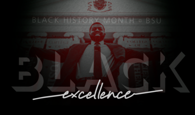 A man stands behind the words "excellence" 
