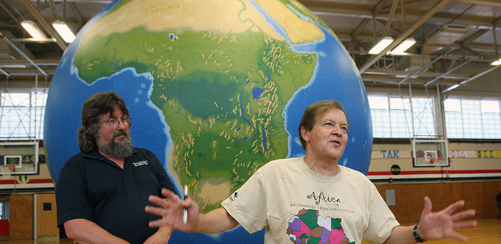 Dr. James Hayes-Bohanan and Dr. Vernon Domingo demonstrating an Earth View Globe in the Kelly Gymnasium