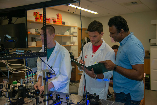 BSU Professor Thaya Paramanathan and 2 physics students work in the Single Molecule Lab