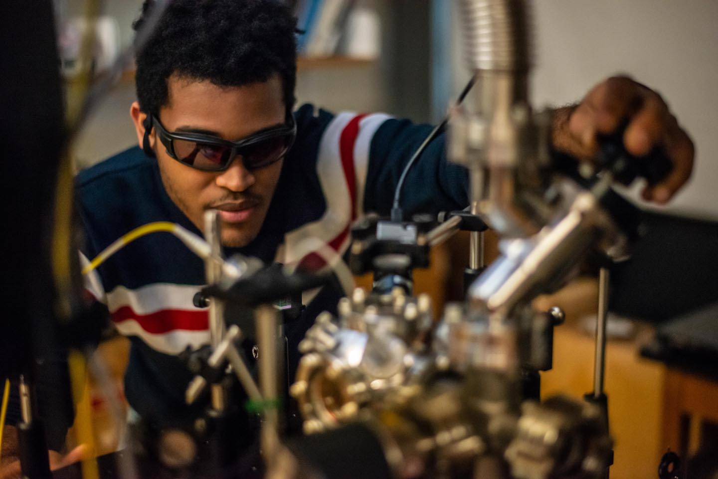 Student performs a photonics demonstration
