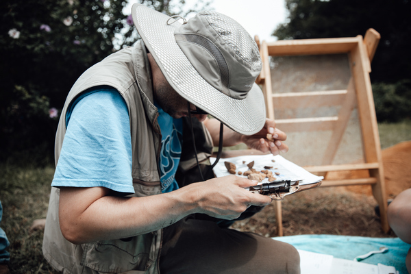 a person examining artifacts