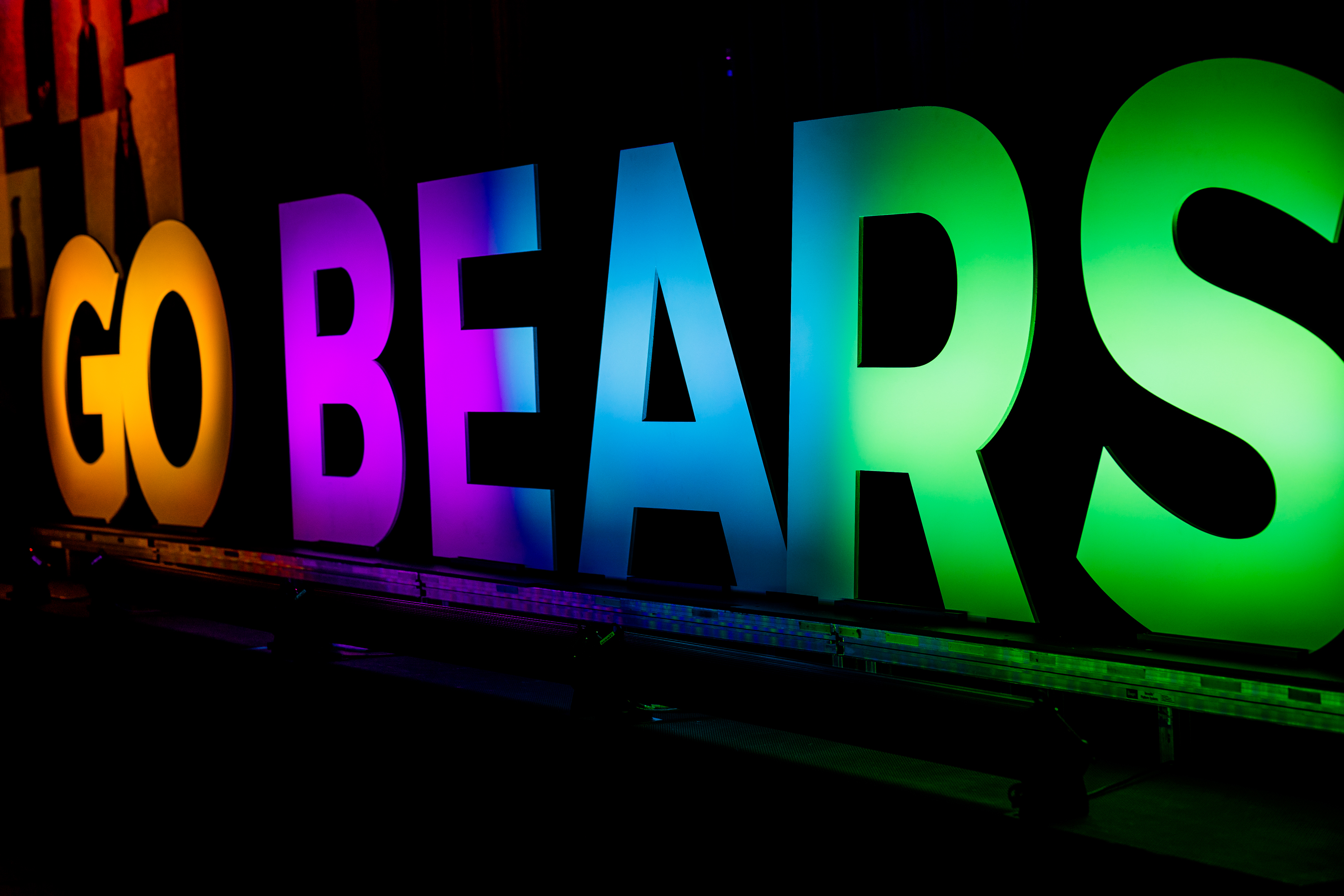 large light up capital letters that say GO BEARS in rainbow colors