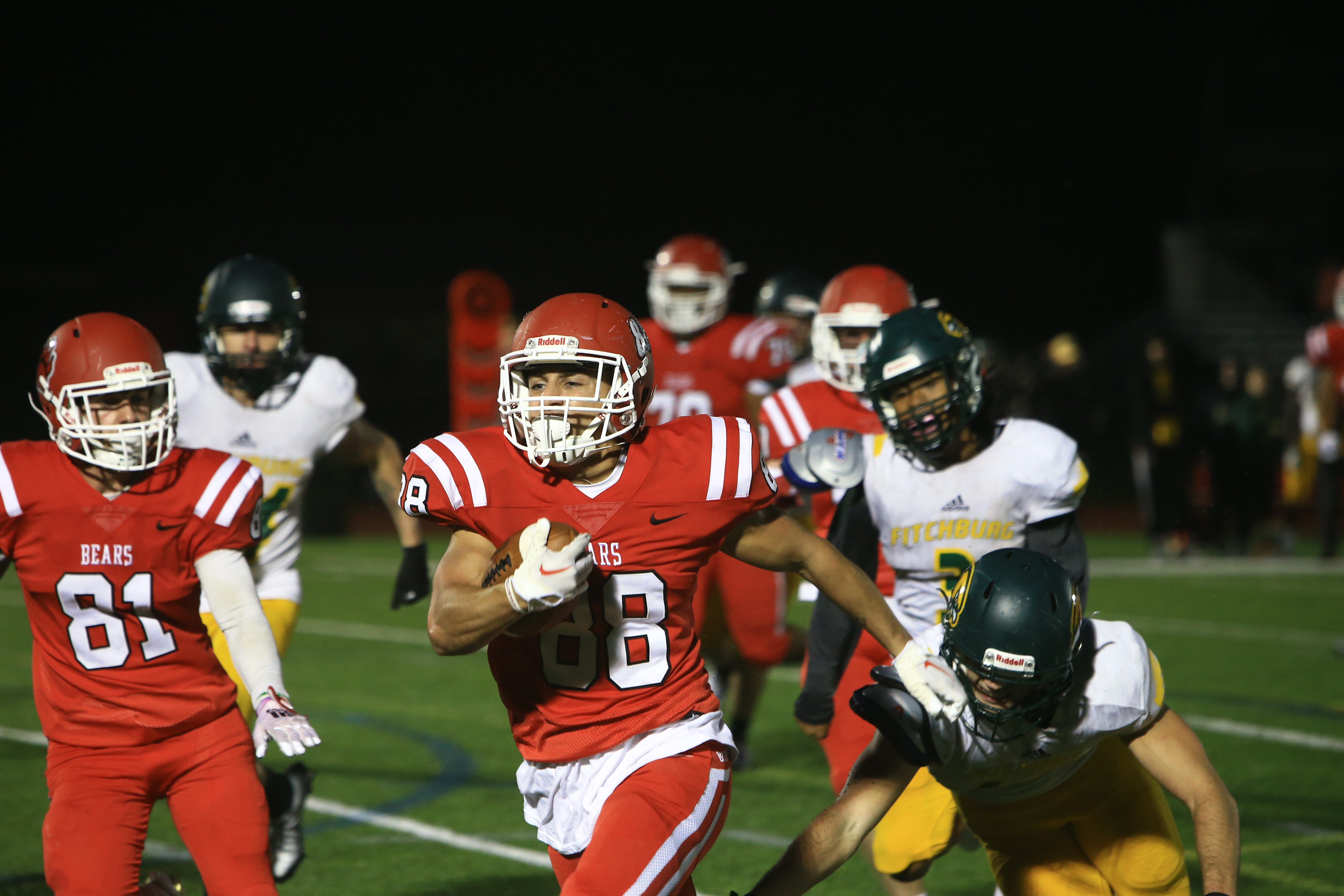 A BSU football player running with the football during the homecoming game