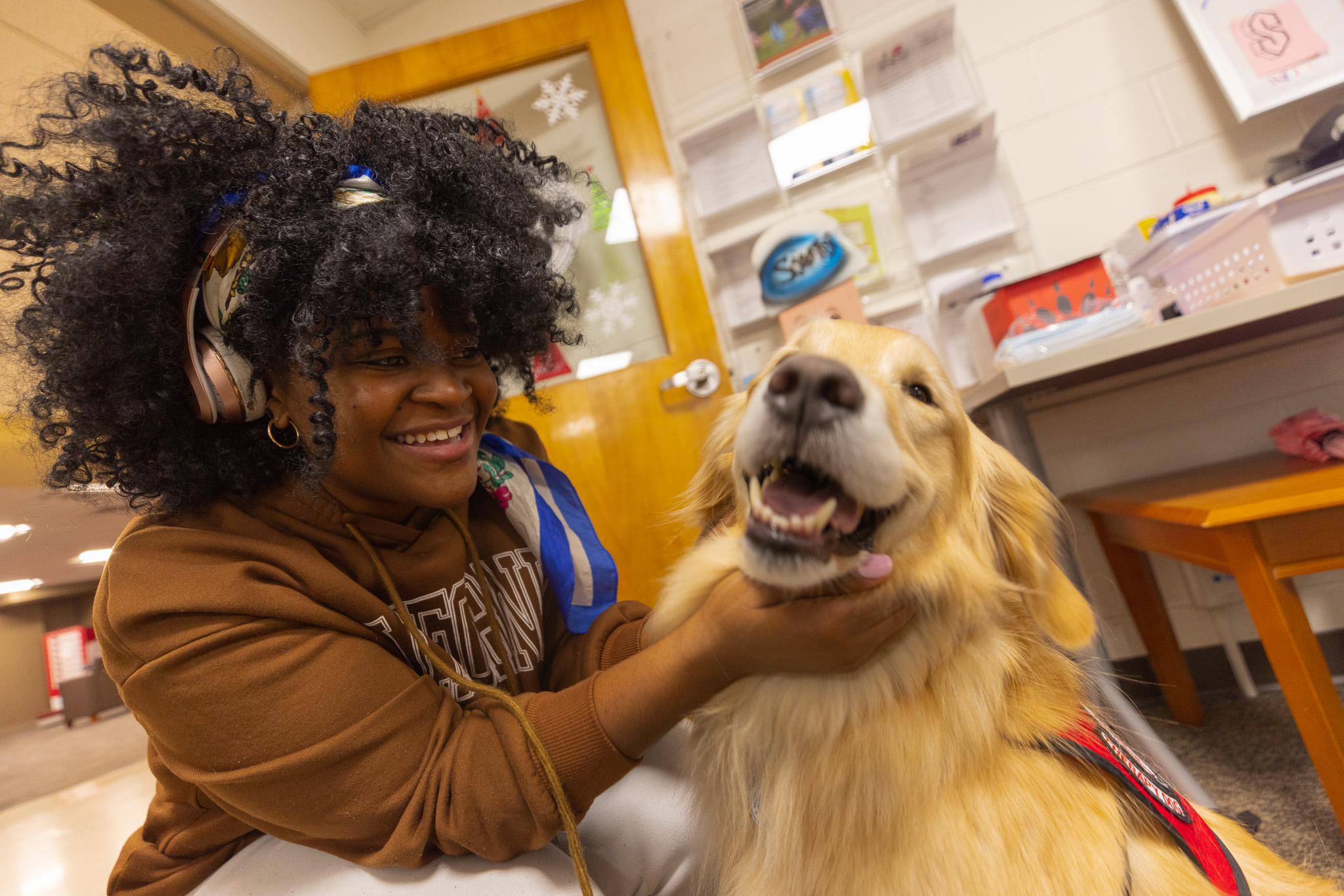 A student petting a therapy dog