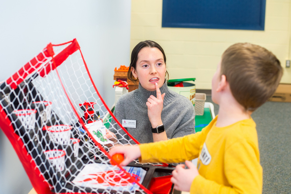 a BSU student working with a child in the Speech Language Literacy Center