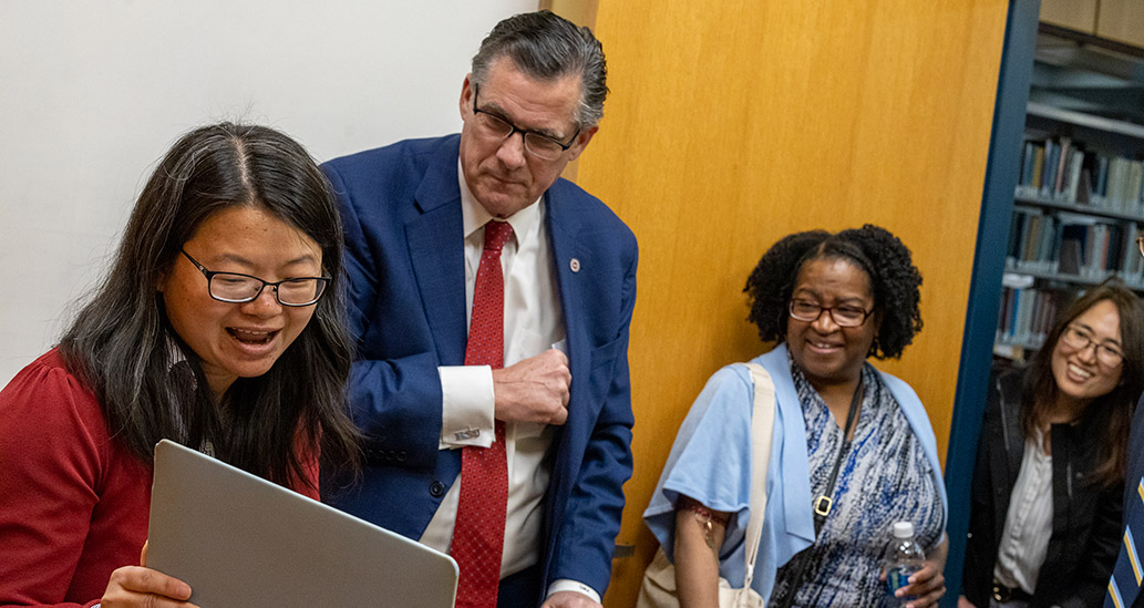 Dr. Xiangrong Liu receiving an award from President Clark. Drs. Davis-Street and Kim look on.