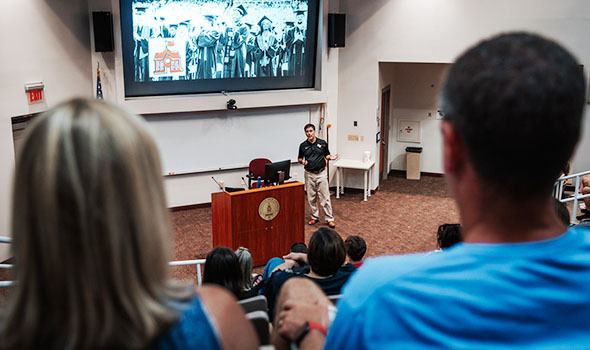 A view from the audience of an undergraduate information session. The associate dean of admission gives a presentation about Bridgewater State University.