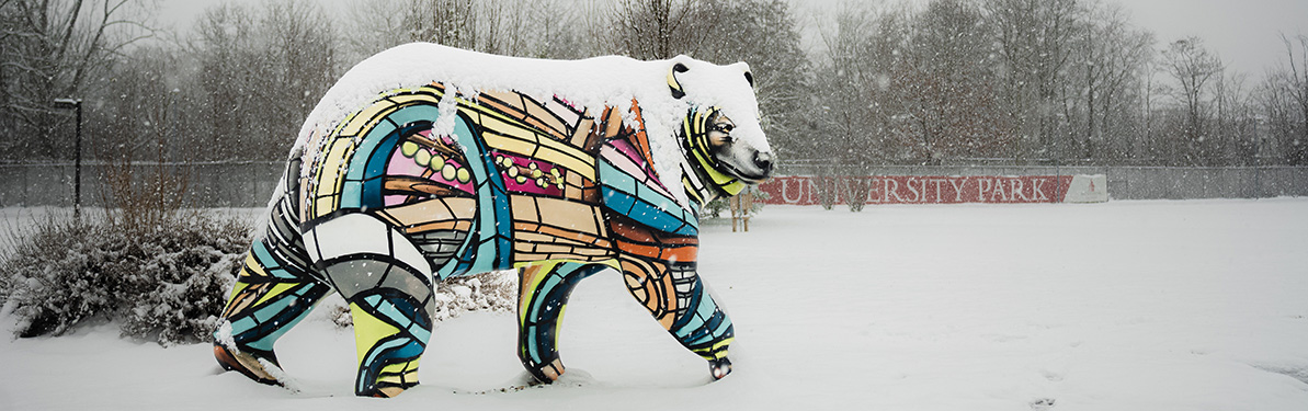 A bear statue in BSU University park during snowfall