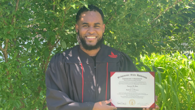 Emanuel De Pina, '20 holds up his degree