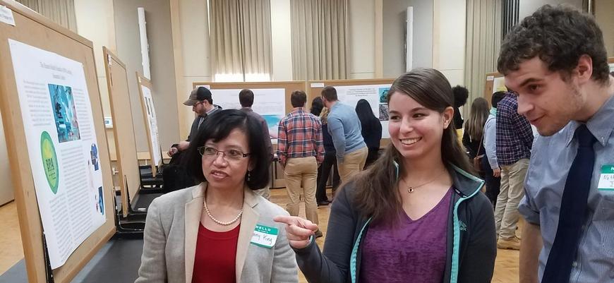 3 people looking at projects at the BSU Environmental Symposium