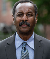 headshot photo of BSU Trustee Walter Prince wearing blue button up shirt, tie and blazer