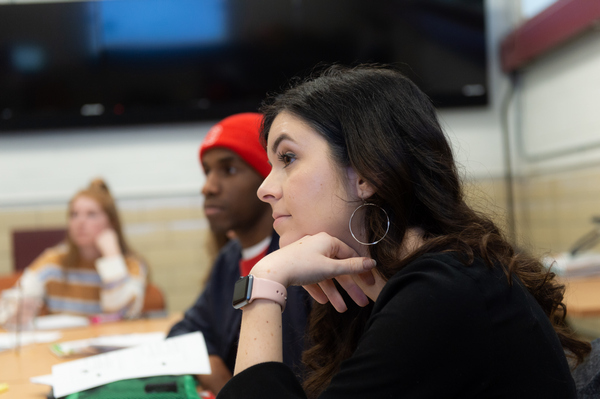students sitting around a table in a classroom