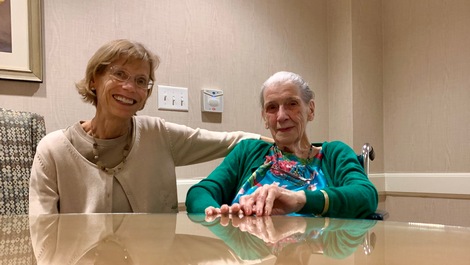 Maggie Lowe and Ruth Calhoun sit at a table.