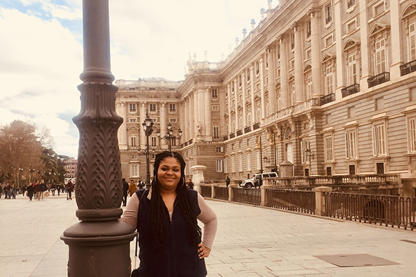BSU student Brittany Christian standing in front of a large ornate building in Madrid, Spain, while on study abroad