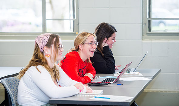 classroom-fin-aid-cta-0822.jpg Three students taking notes in Intro to Special Education