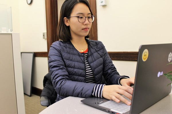 A BSU student sitting at a desk working on her computer