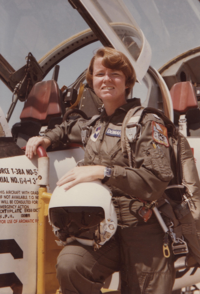 Mary Donahue stands next to an airplane wearing her military uniform.