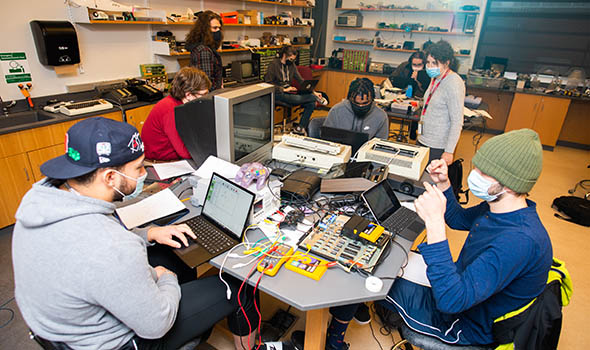 intro-comp-org-cta-0822.jpg Students in a computer organization class around a desk filled with computer equipment