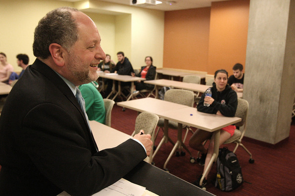 Dr. Aeon Skoble smiling at a podium in Philosophy class
