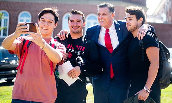 President Clark stops to take a selfie with eager students