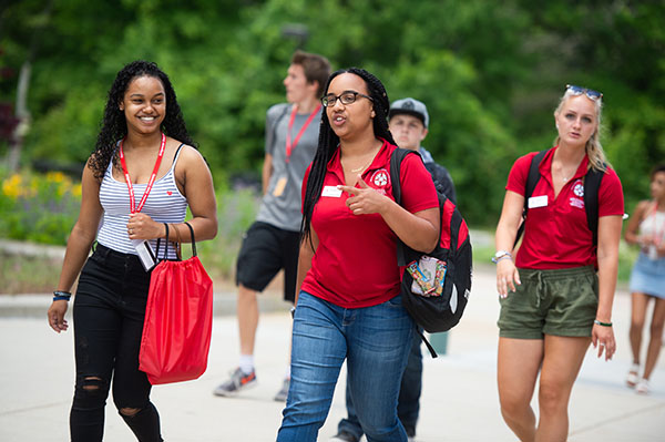 student_guided_tours_cta.jpg a female student in a red BSU shirt walking and talking with a new BSU student