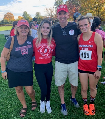 The Sweeney family stands next to each other at Elisabeth's cross country meet.
