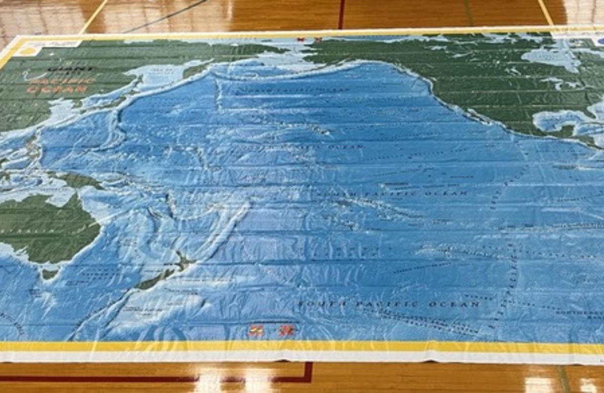An overhead shot of a giant map of the Pacific Ocean