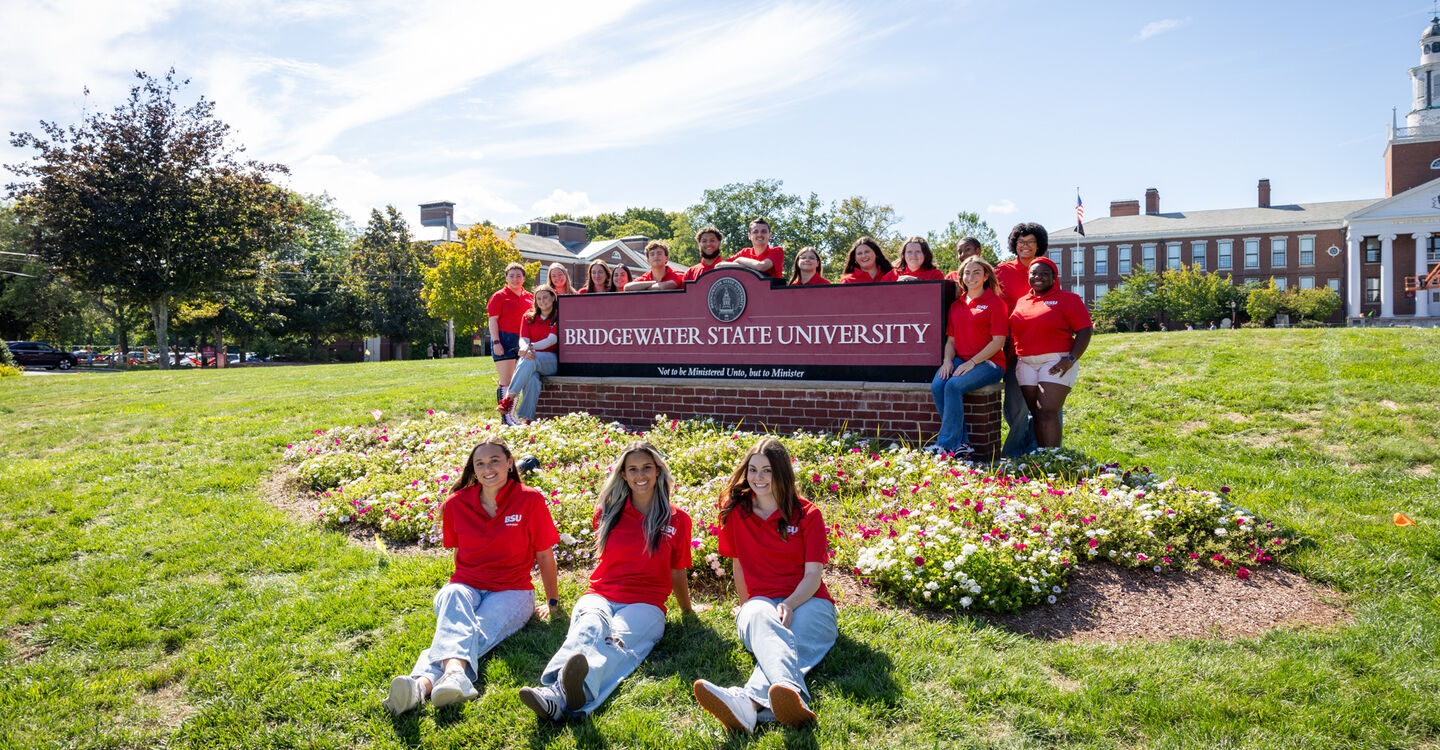 BSU student tour guides around the BSU sign on Boyden Quad