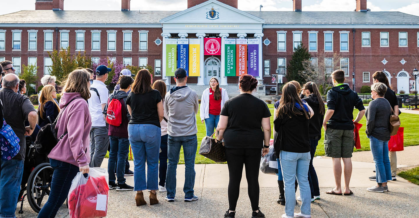 A group of prospective students listening to their tour guide outside of Boyden Hall