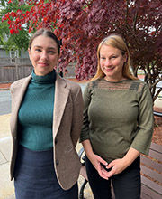 Dr. Jamie Huff and Dr. Emily Field standing in front of a tree on campus