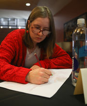 Olivia Dunn, '24, writing on a piece of paper during a Life Design session
