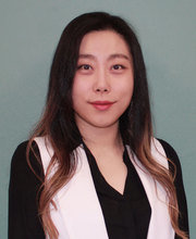 headshot photo of Dr. Hannarae Lee with long dark brown hair, wearing a black v-neck long sleeve top with a light pink vest