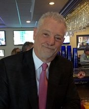 Dr. Bob MacMillan dressed in suit and tie