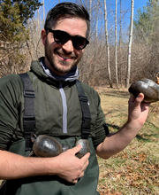Dr. Michael Graziano outside holding 3 turtles