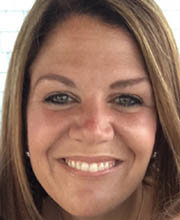 close up headshot of Emily Holmes smiling with straight dark blonde hair