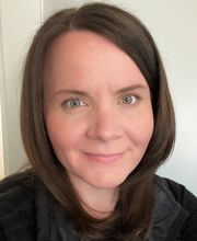 headshot photo of Dr. Wendy Knight smiling with medium length straight brown hair wearing a black top