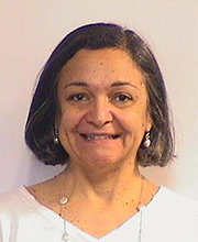 headshot photo of Teresa Mascarenhas smiling with medium length straight dark brown hair wearing a v-neck white top