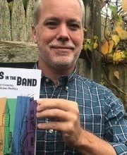 Matt Bell holding a copy of the book The Boys in the Band