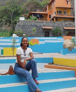 smiling woman sitting on brightly colored steps