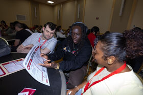 A group of people sit at a table and talk