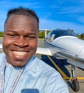 Kendell French stands next to a BSU plane.