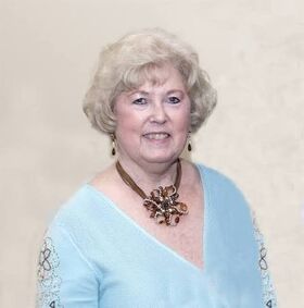 Headshot of Marilyn Barry wearing a blue shirt