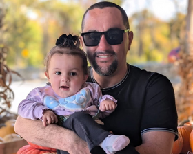 A man holds a small child