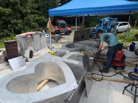A student uses a tool to make a Heart BSU scuplture.