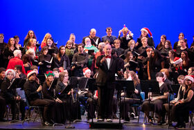 A group of people stand and take a bow on a stage