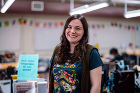 Woman stands smiling
